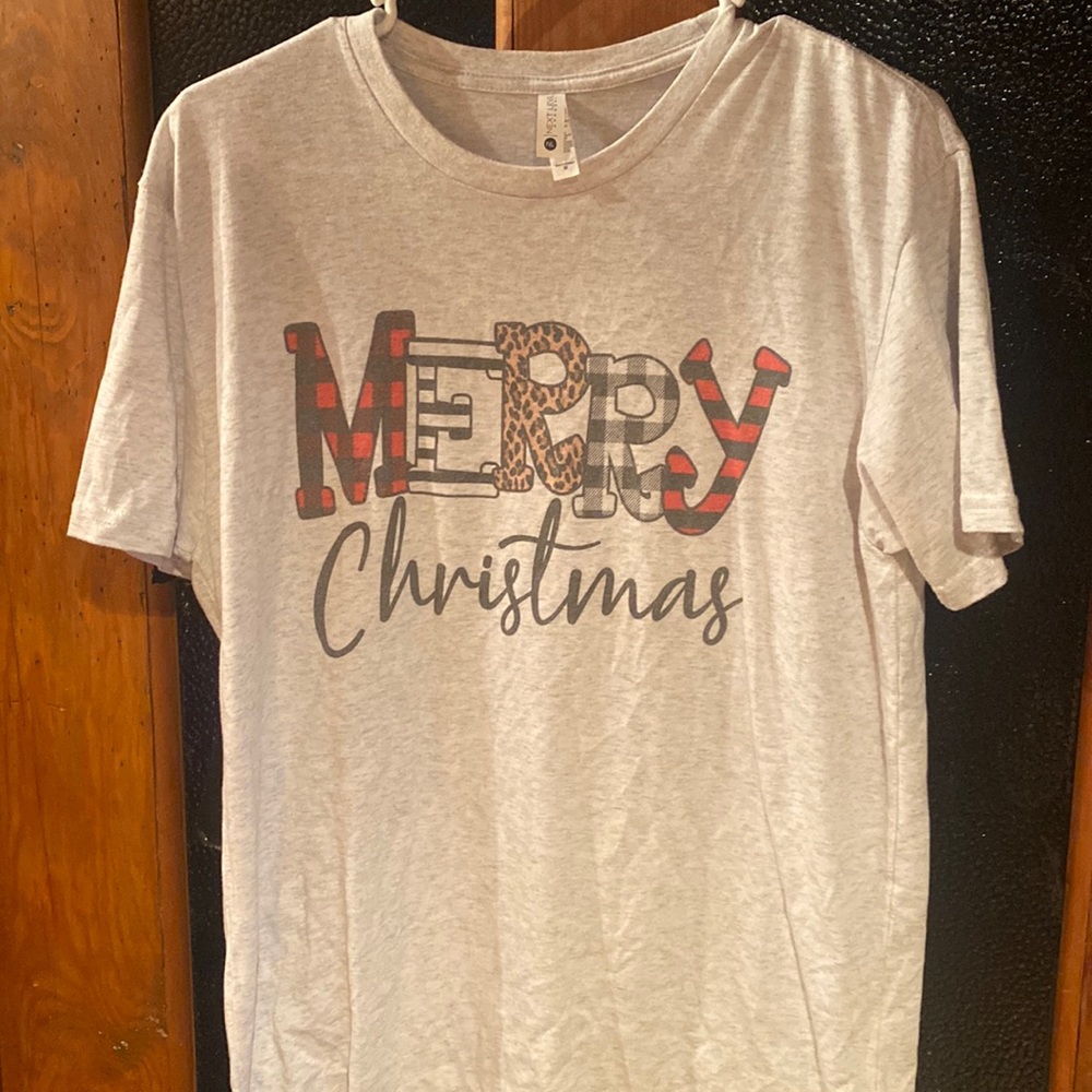 Short sleeve T-shirt that says merry Christmas in plaid and cheetah print